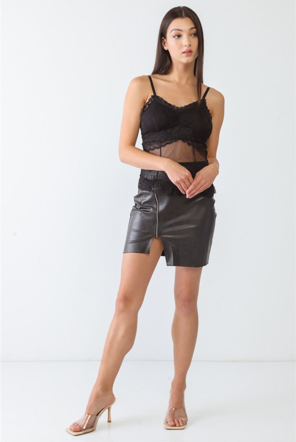 A woman models a sophisticated black lace bustier top with sheer panel detailing, epitomizing modern elegance.