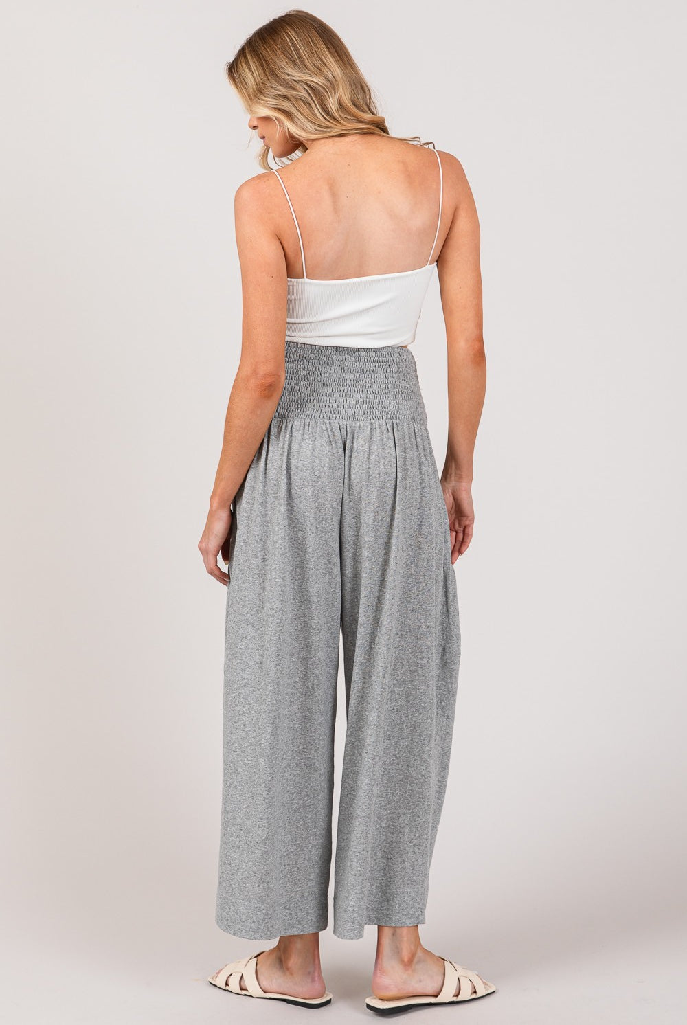 Woman wearing stylish gray high waist smocked drawstring pants, perfect for chic outfits.