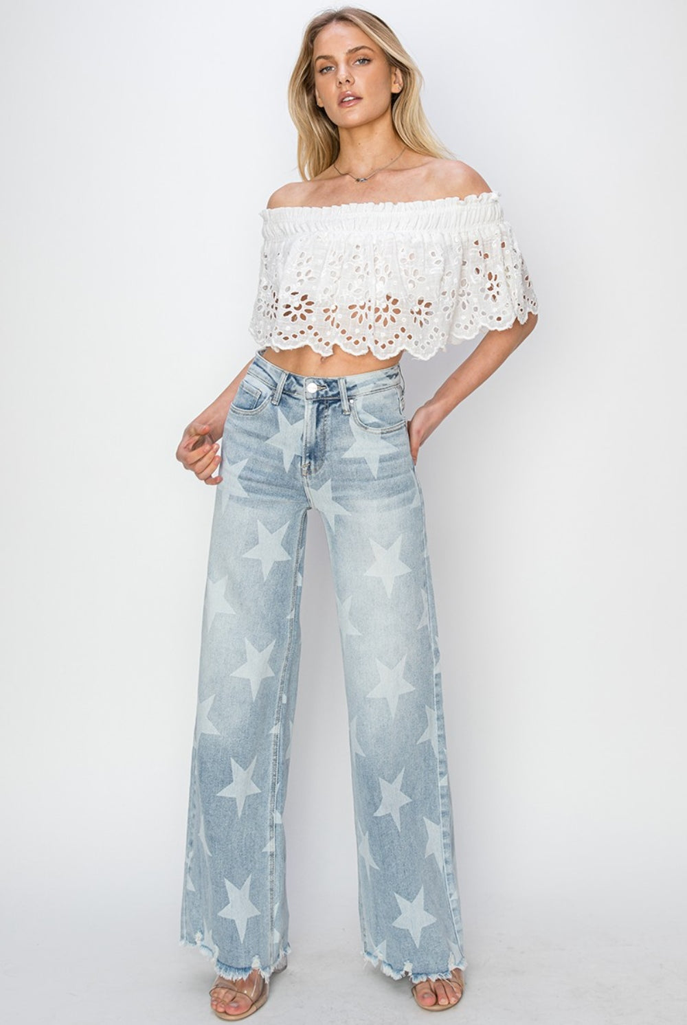 Fashion-forward wide-leg jeans with star print and frayed hem, channeling a celestial vibe.