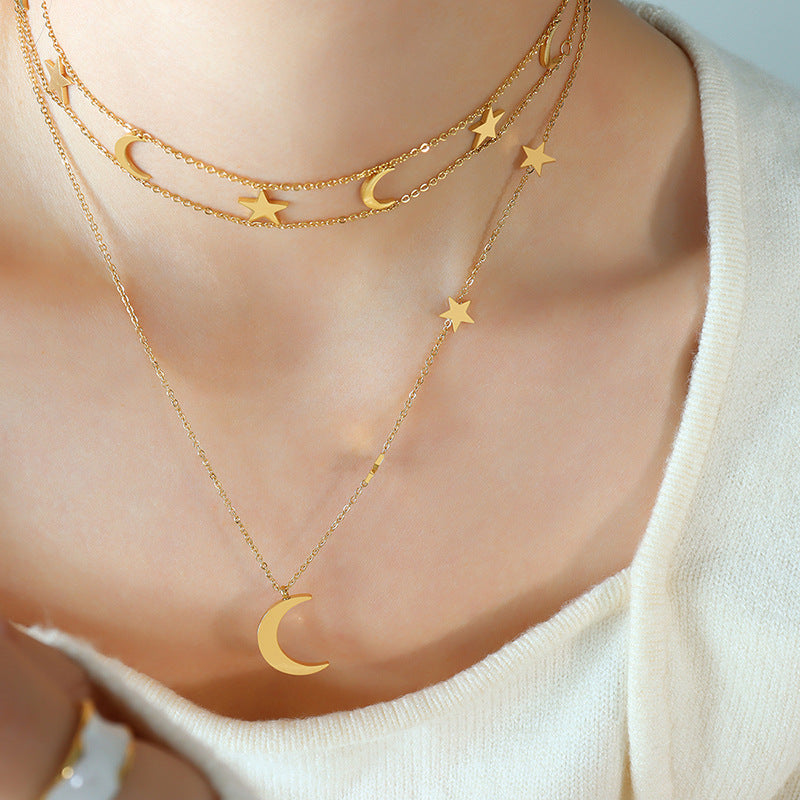 Elegant titanium necklace with moon and star charms on a woman's neck