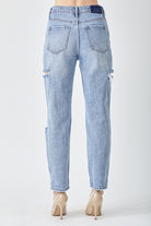 Woman wearing slim cropped distressed blue jeans, perfect for casual chic sty