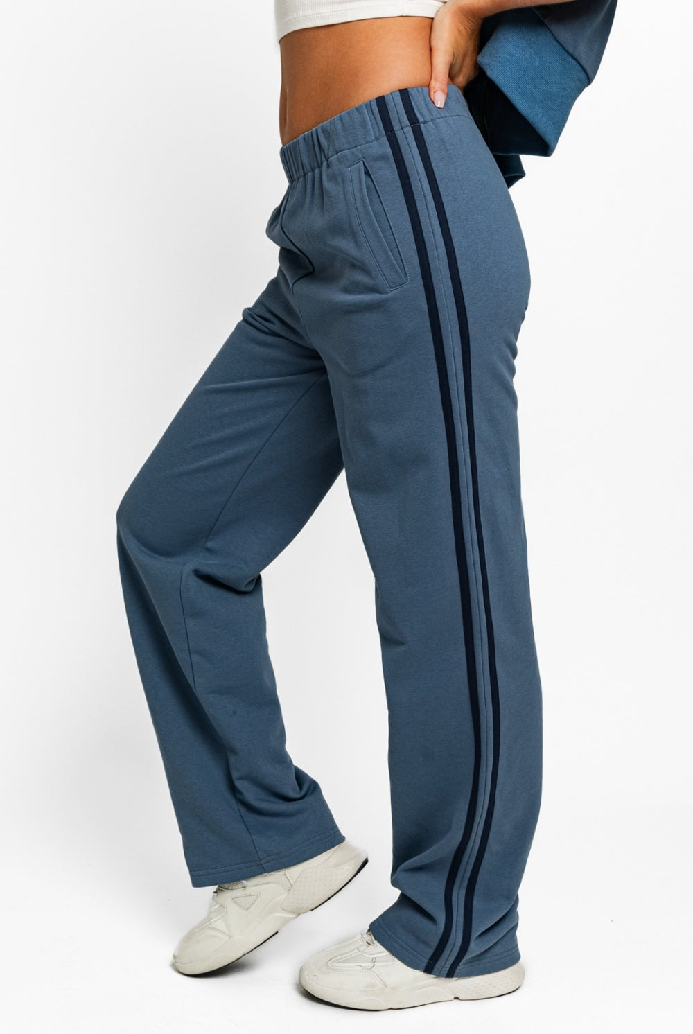 Model showcasing GemThreads Boutique's Side-Stripe Cozy Sweatpants in blue.