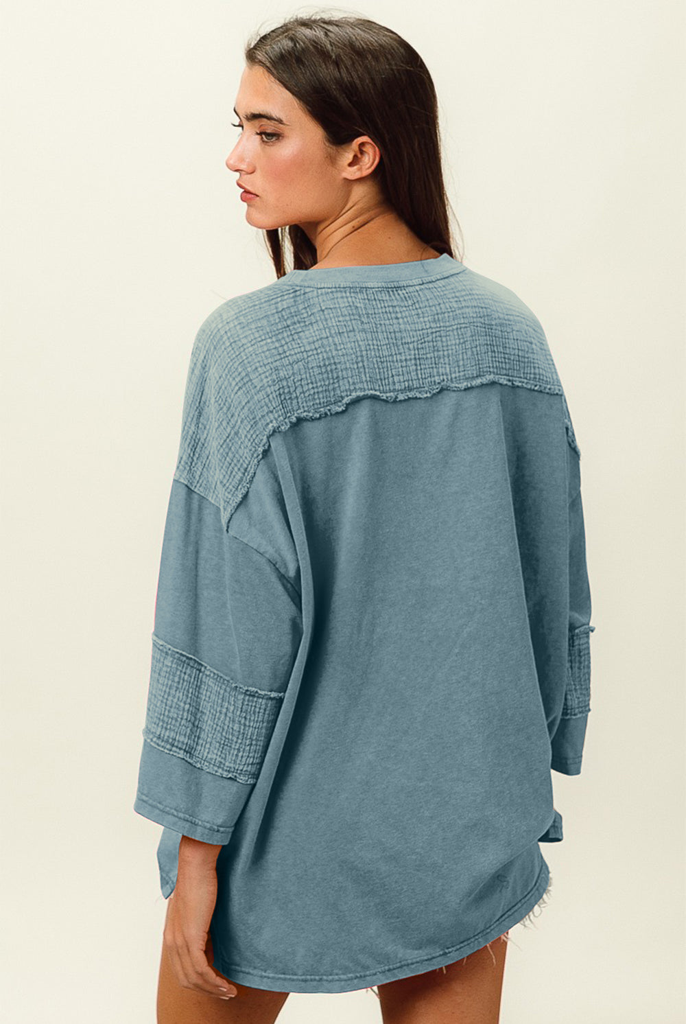 Woman in denim washed long-sleeve t-shirt with pocket detail