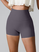 Active woman in GemThreads Boutique's high-waisted active shorts, with phone tucked in back pocket.