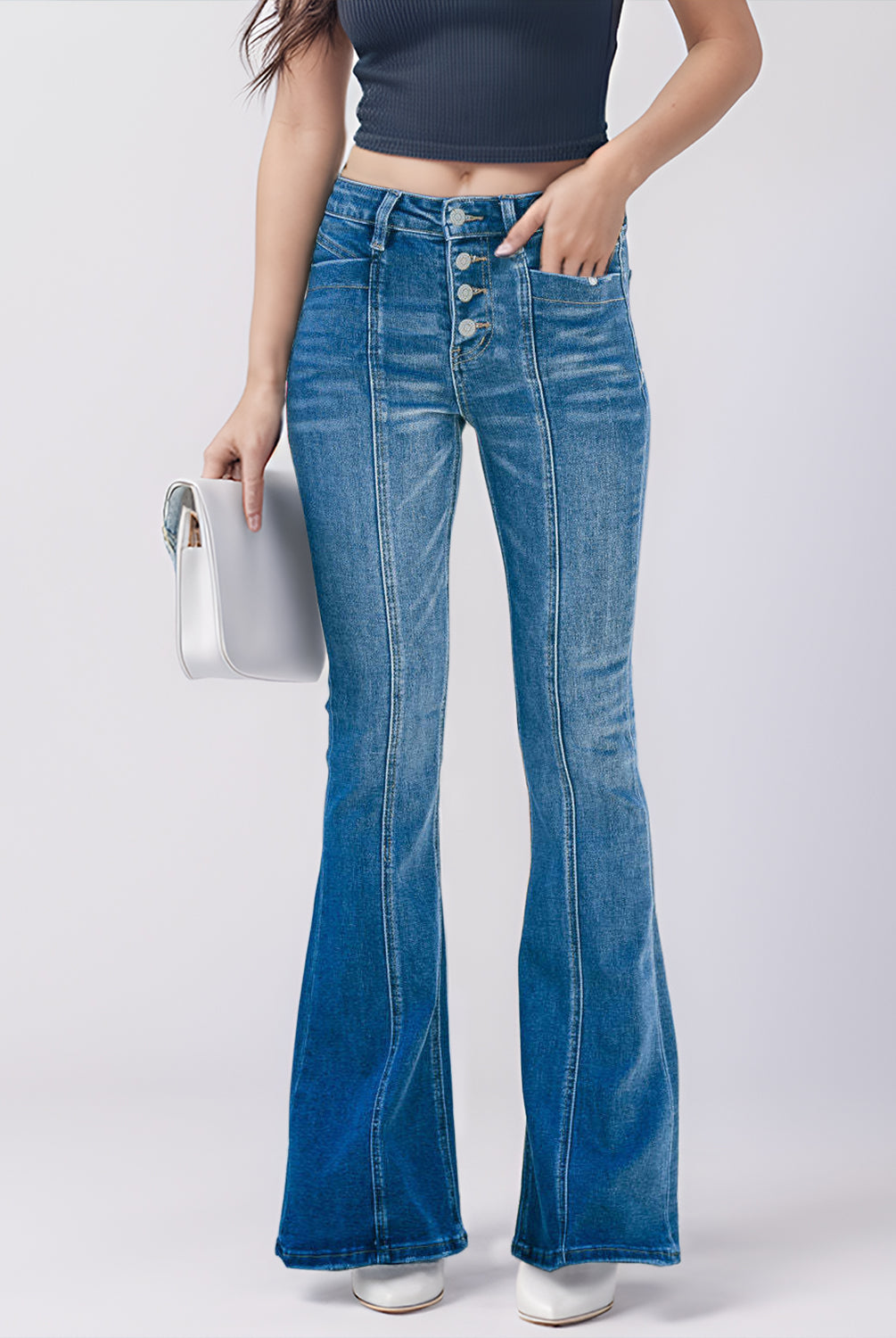 Trendsetting woman sporting high-waist bootcut denim jeans, ideal for a chic throwback look.