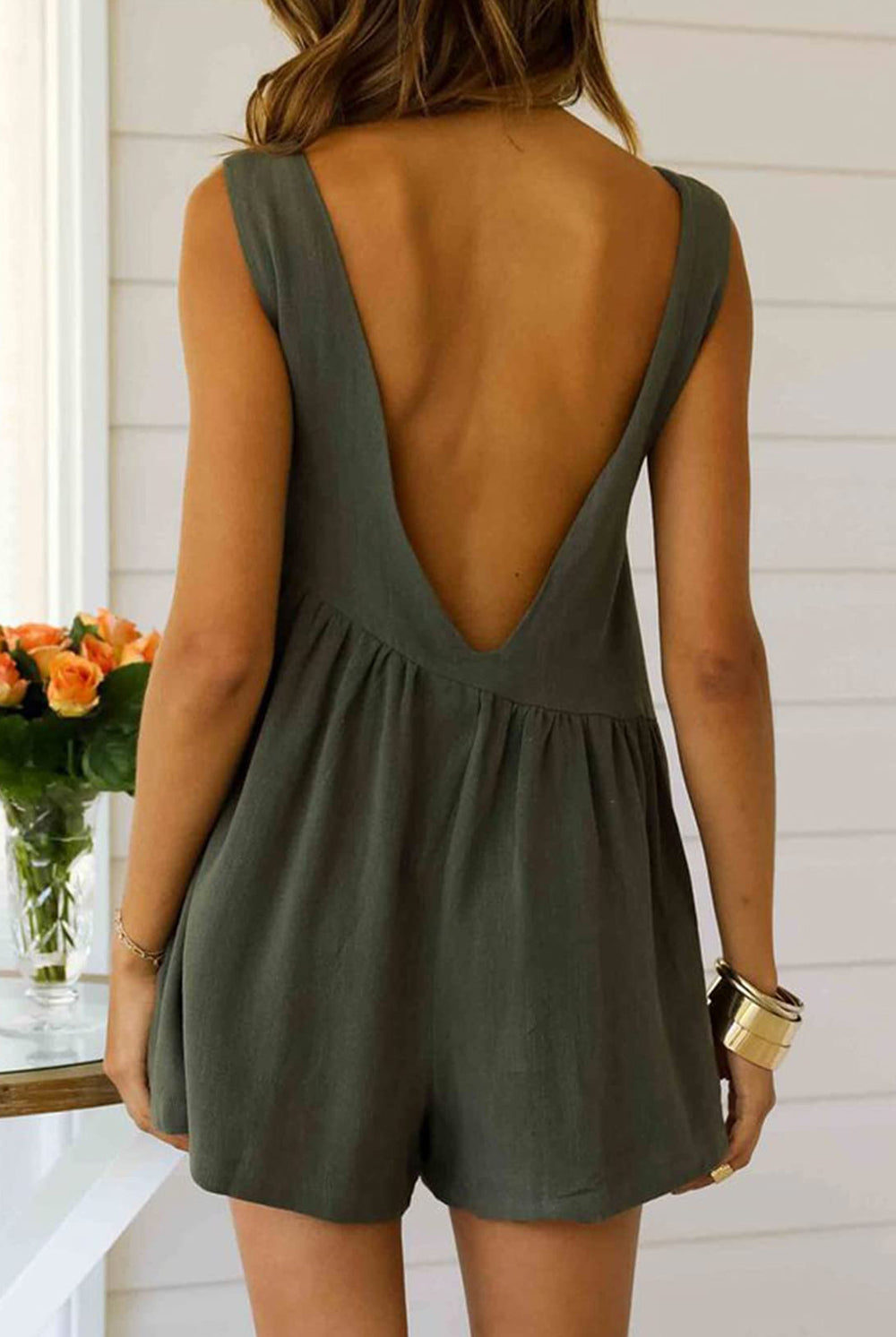 Stylish woman in a Chic Olive Backless Romper, exuding confidence and summer-ready vibes with a flattering and breezy silhouette.