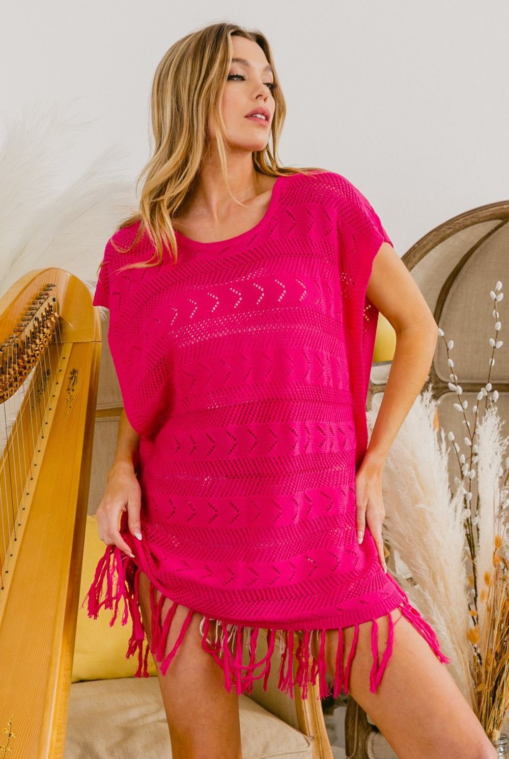 Stylish individual in a bohemian fringe knit top, ideal for a trendy, laid-back look.