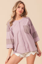Woman wearing a casual lavender washed t-shirt with a textured pocket