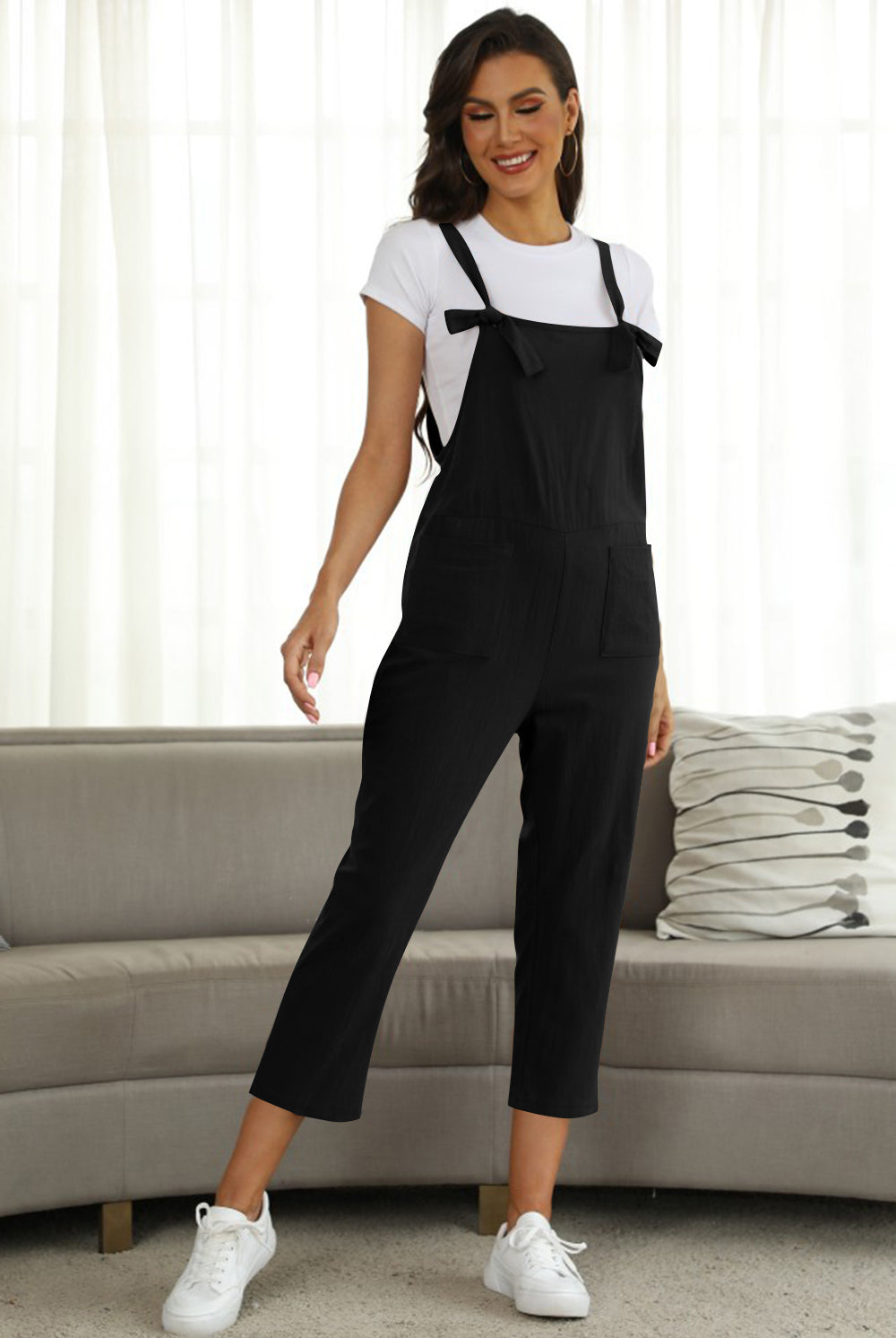 Fashion-forward woman in a wide leg jumpsuit with tie straps, a must-have in every stylish wardrobe, available at GemThreads Boutique.