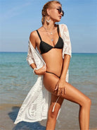  Fashionable woman wearing a white cover up with half sleeves on the beach.