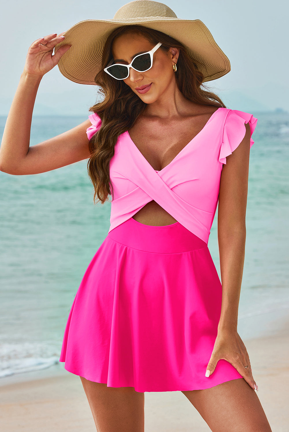 Model wearing a chic cutout one-piece swimsuit, available in black and pink options