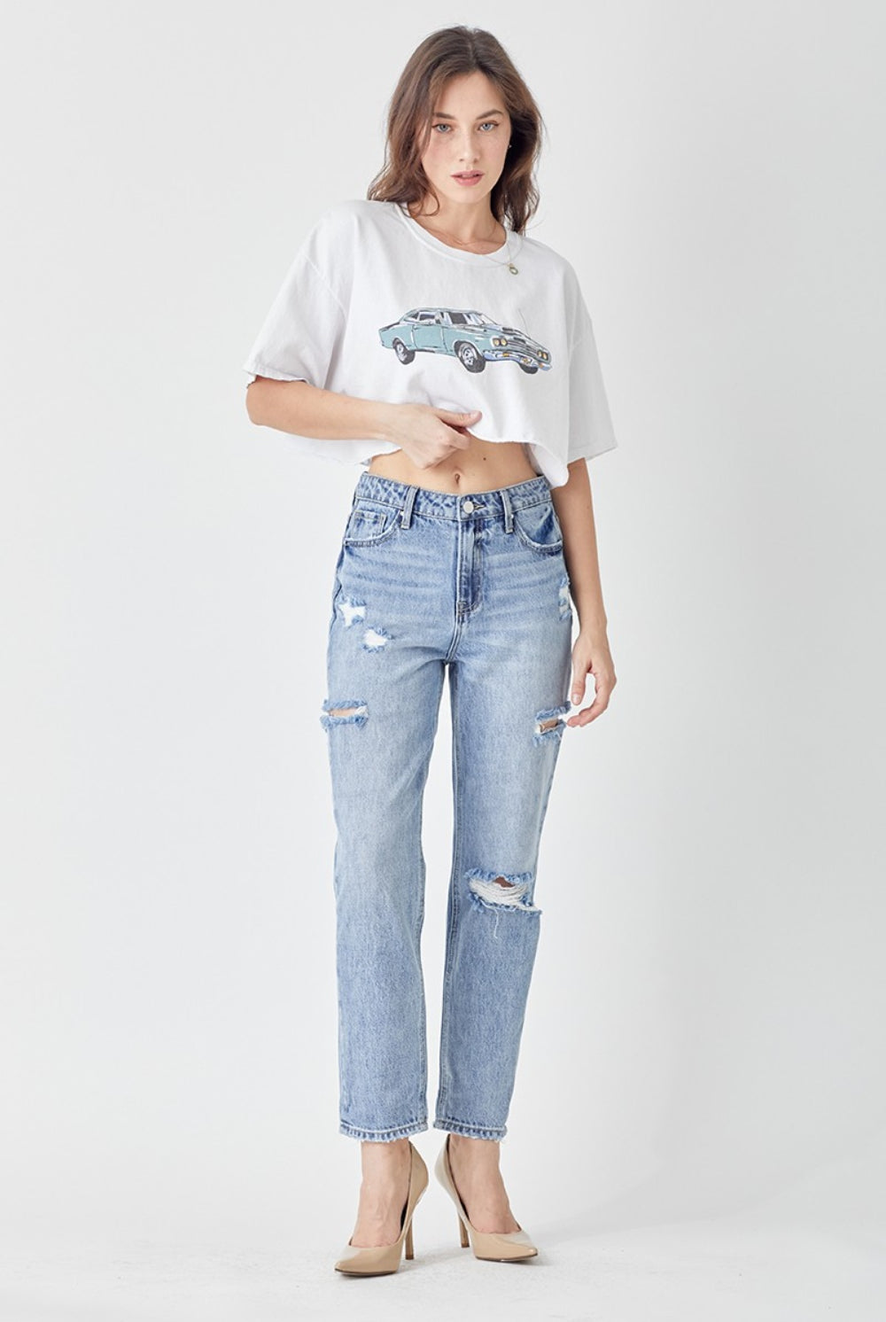 Woman wearing slim cropped distressed blue jeans, perfect for casual chic sty