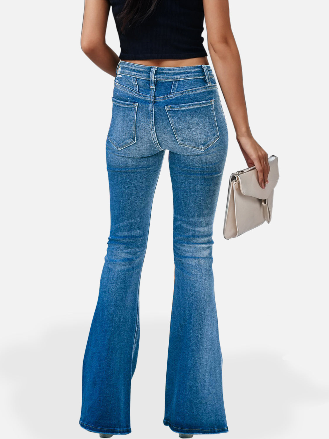 Trendsetting woman sporting high-waist bootcut denim jeans, ideal for a chic throwback look.