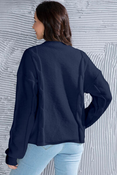 Button up V-neck cardigan with drop shoulders and long sleeves, featuring a ribbed waistband and cuffs, with front button closure for a versatile fit. Perfect for layering over a variety of outfits.