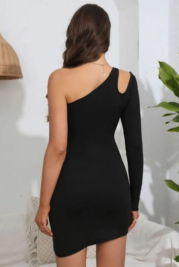 A model poses in a one-shoulder black bodycon dress with an asymmetrical neckline and gathered side detail, from GemThreads Boutique.