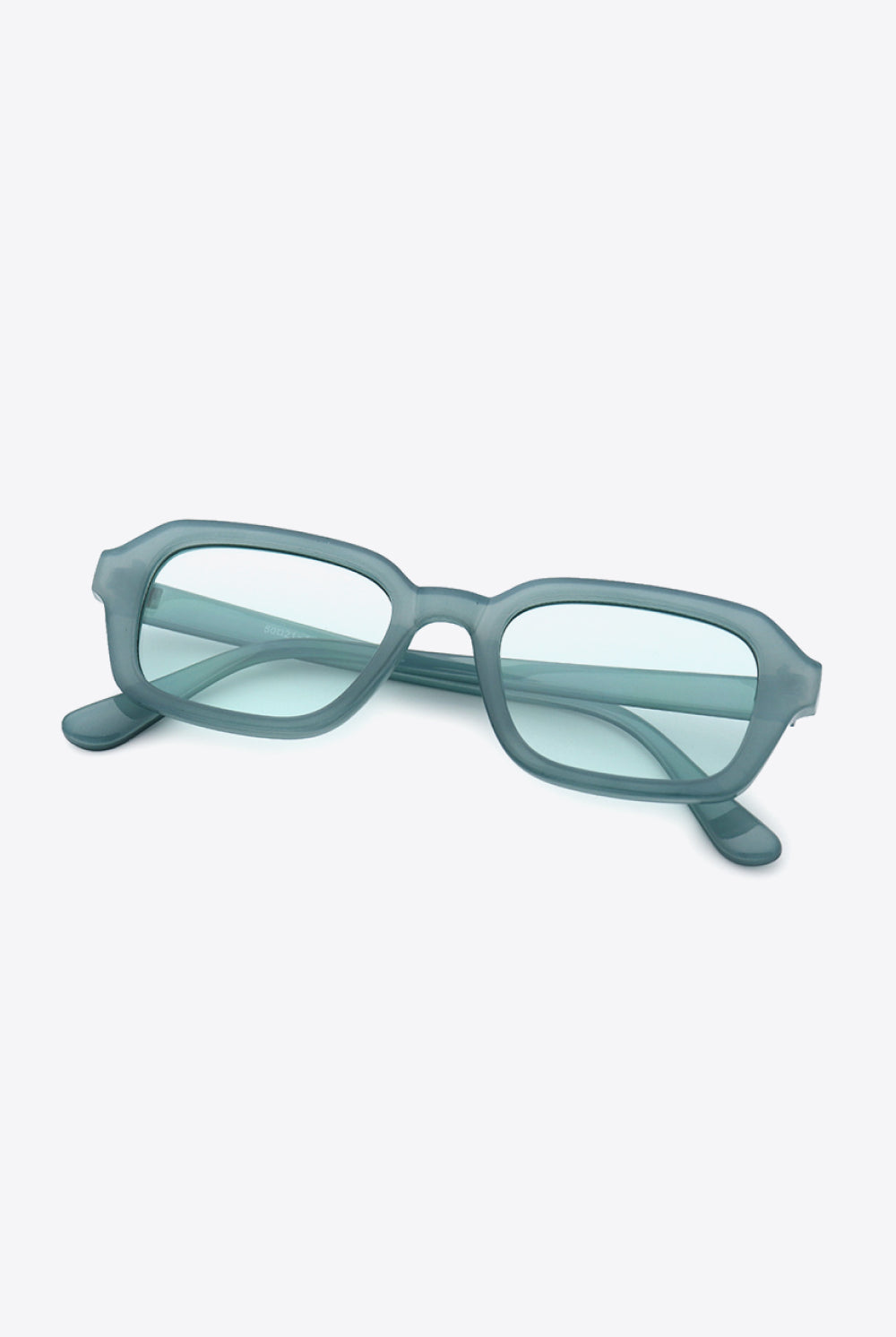A pair of translucent grey, rectangle full-rim sunglasses, showcasing a modern and minimalist design with smooth lines and a subtle elegance, perfect for adding a contemporary touch to any ensemble.