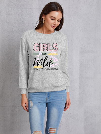 Women's round neck sweatshirt with 'GIRLS ARE WILD NEVER STOP DREAMING' print and floral embroidery.