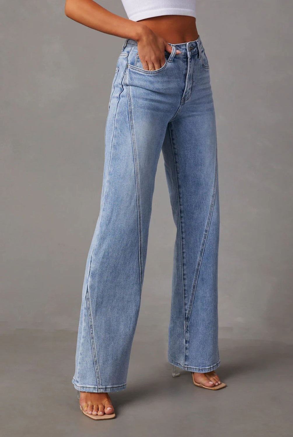 A model showcases Classic High-Waist Straight-Leg Jeans in a light blue wash, complementing the look with a cropped white top and minimalist open-toe heels for an understated yet chic appearance.