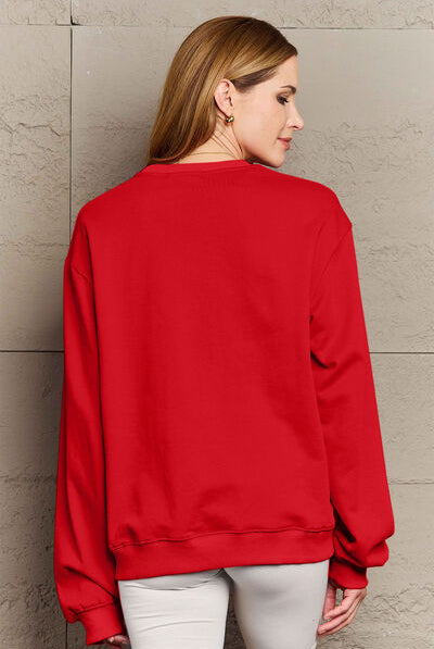 Woman modeling a red round neck sweatshirt with the text "I'D RATHER BE SLEEPING" printed on the front, paired with white shorts.