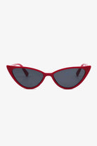 Red cat-eye sunglasses with dark lenses on a white background, showcasing a retro-inspired design with a modern twist.