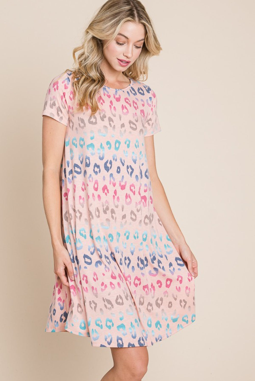 Happy woman wearing a Playful Pastel Leopard Print Short Sleeve Dress, embodying a cheerful and stylish vibe, perfect for spring and summer days.