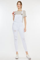 Stylish woman wearing women's distressed overalls, ideal for a relaxed yet fashionable outfit, available at GemThreads Boutique.