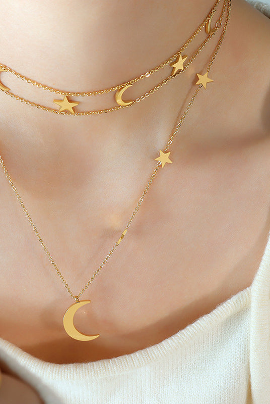 Elegant titanium necklace with moon and star charms on a woman's neck