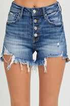 Model displaying stylish frayed denim shorts with button-up detail, perfect for a summer-ready casual look.
