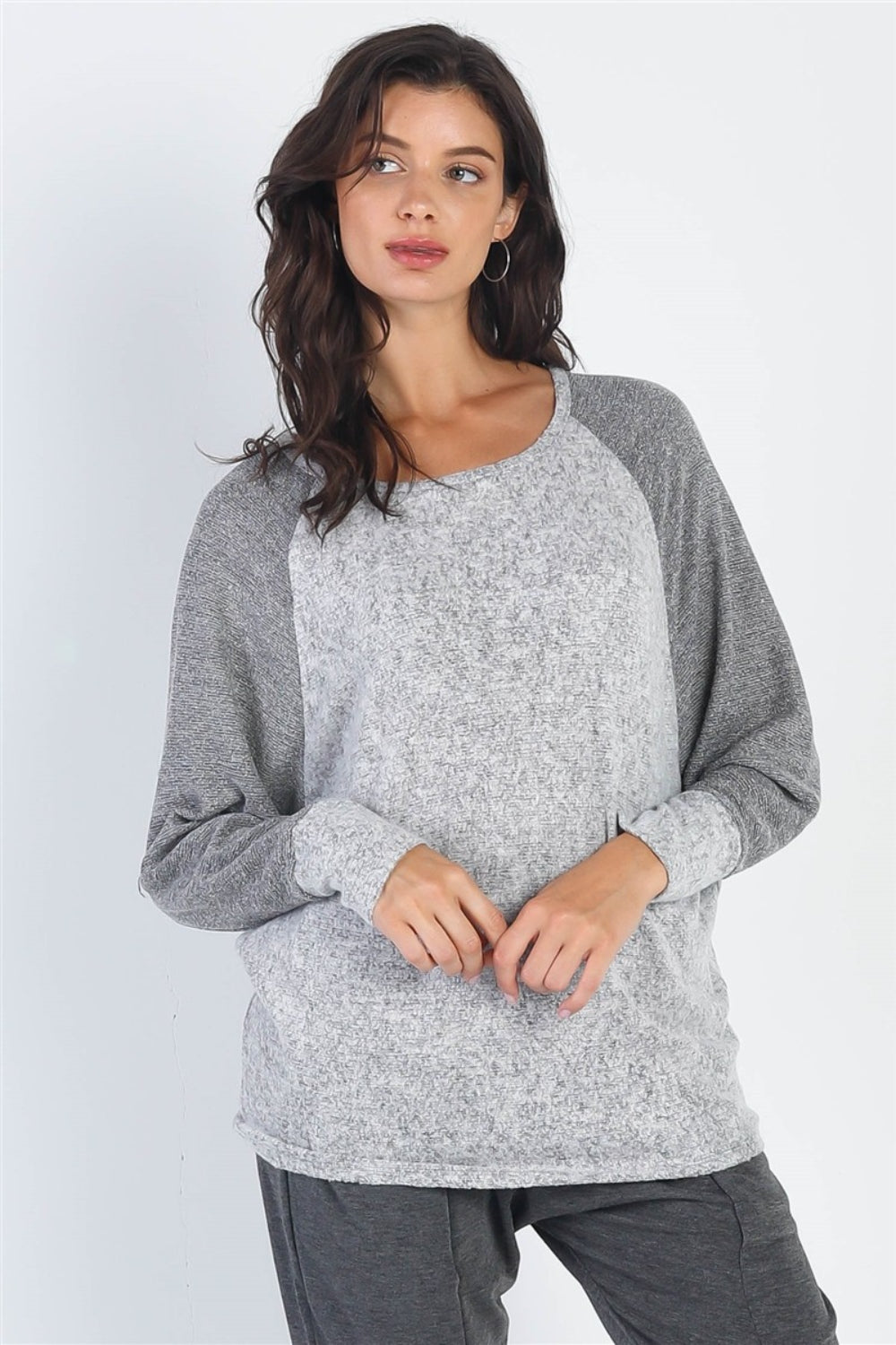 A woman modeling a casual long sleeve contrast top in shades of burgundy and grey, perfect for a stylish yet comfortable outing.