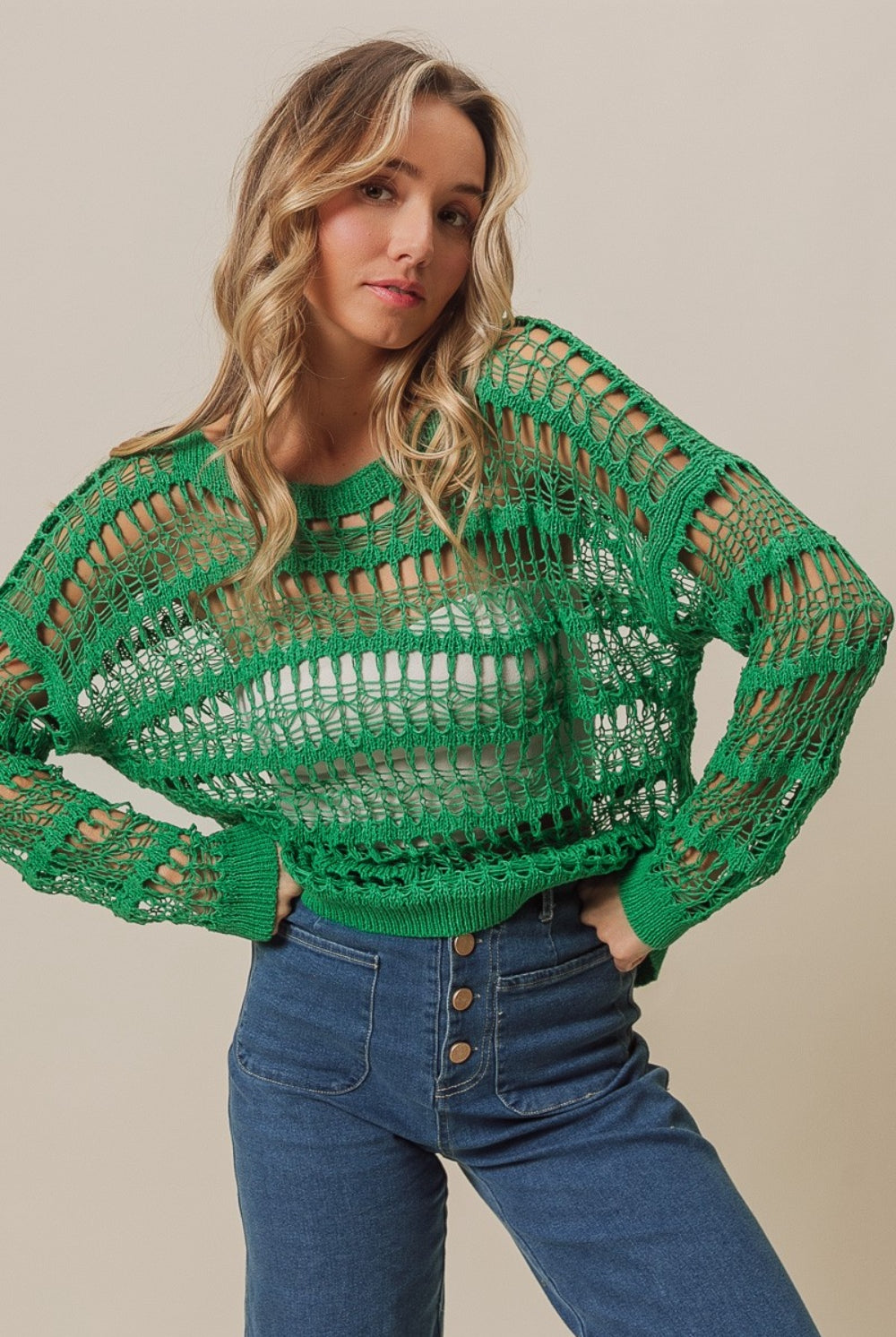 Woman modeling a green long sleeve crochet knit cover up
