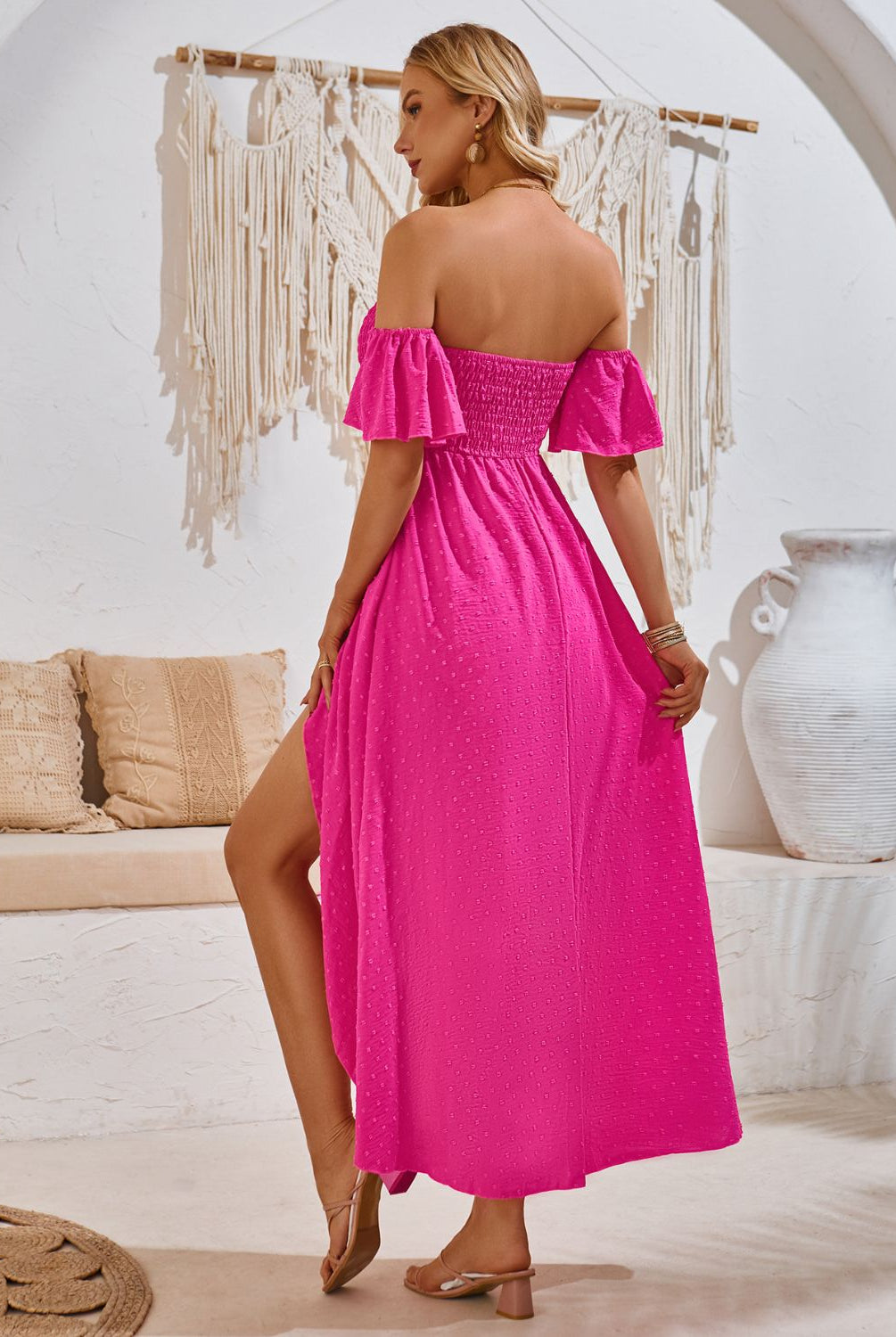 Woman in a chic hot pink .0smocked midi dress with a high-low hem, perfect for a summer day.