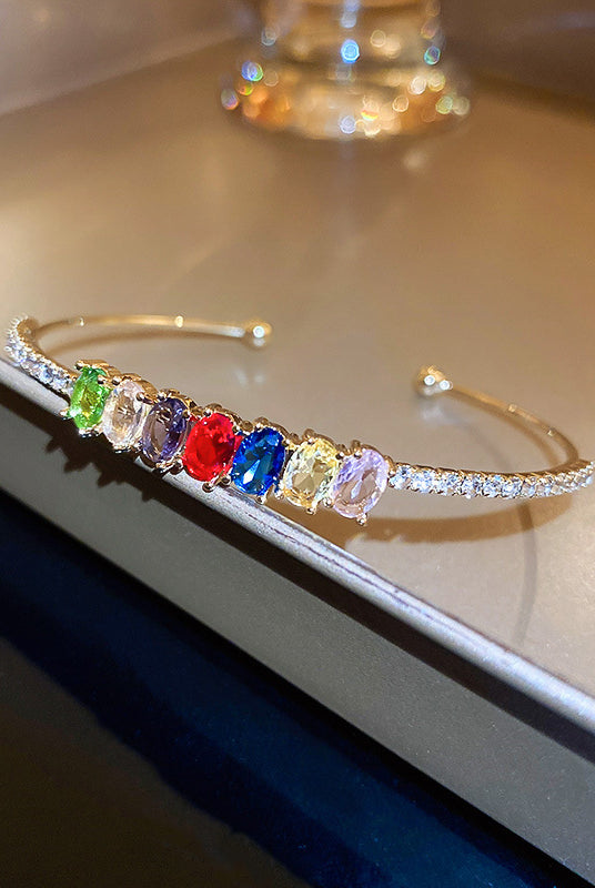 Elegant rhinestone bracelet cuff displaying a rainbow of colors, perfect for adding a sparkling touch to any outfit.