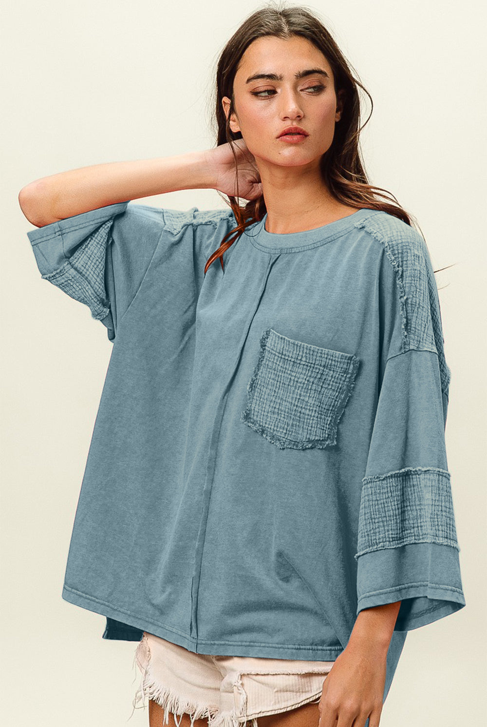 Woman in denim washed long-sleeve t-shirt with pocket detail