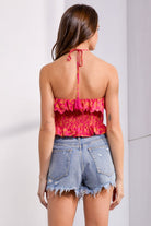 Chic woman in a vibrant pink sleeveless smocked backless top, ideal for stylish summer outings.