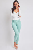 Elegant model wearing chic seafoam mid-rise skinny jeans, epitomizing casual sophistication.