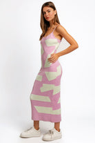 Stylish woman modeling a form-fitting lavender maxi sweater dress with an abstract pattern, perfect for versatile fashion.
