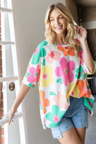 Woman wearing an oversized floral waffle T-shirt in off white, perfect for a casual and vibrant look.