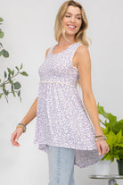 Woman wearing a lilac floral high-low hem tank top, perfect for a casual chic look.