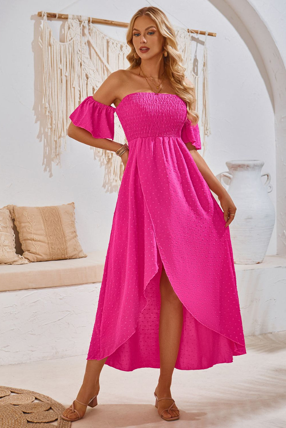 Woman in a chic hot pink smocked midi dress with a high-low hem, perfect for a summer day.